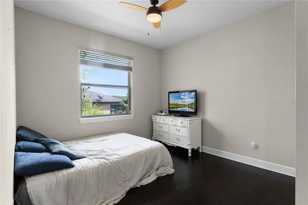 a bedroom with a bed and a tv