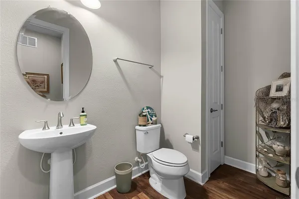a bathroom with a sink toilet and a mirror