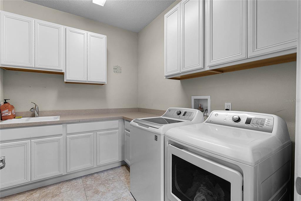 30215 Bretton Loop Mount Dora, FL 32757 - Photo 21 of 32 a utility room with dryer and washer