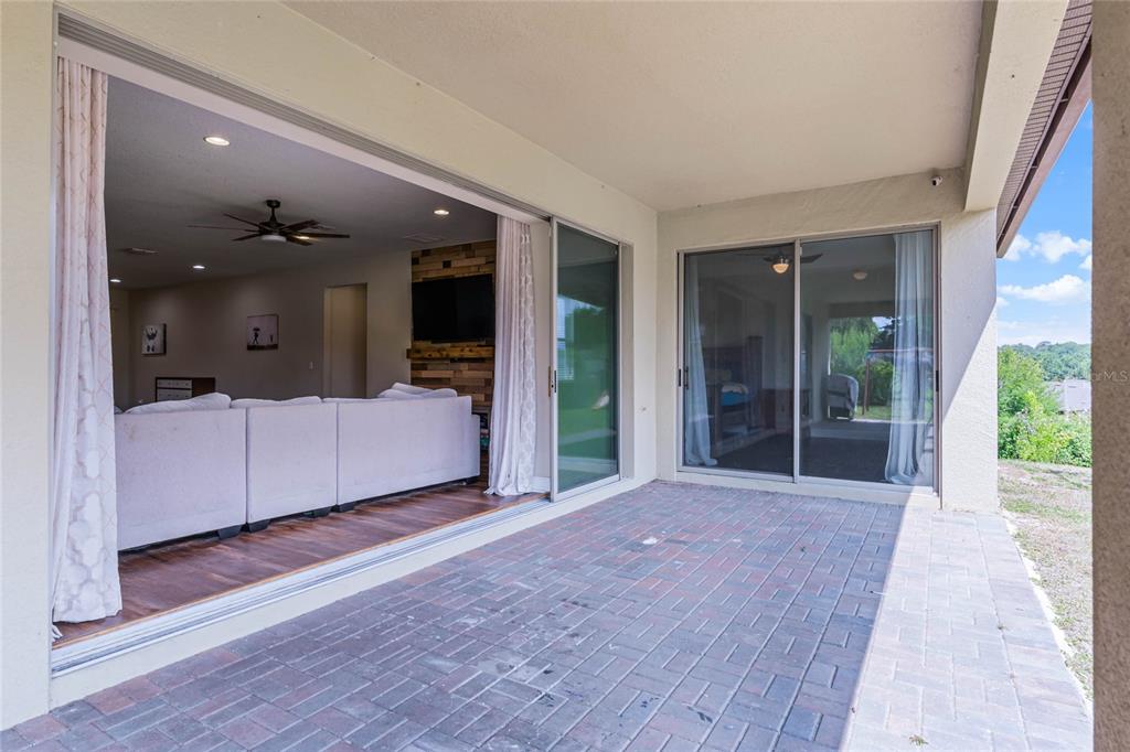 30215 Bretton Loop Mount Dora, FL 32757 - Photo 22 of 32 a view of a big room with wooden floor and windows
