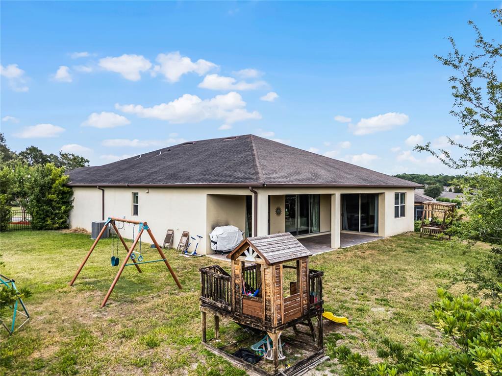 30215 Bretton Loop Mount Dora, FL 32757 - Photo 24 of 32 a backyard of a house with table and chairs