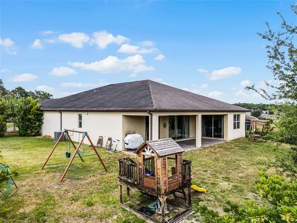 a backyard of a house with table and chairs
