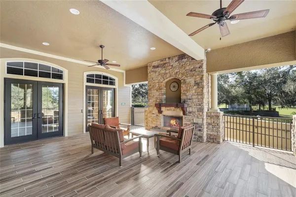 a living room with furniture and a floor to ceiling window