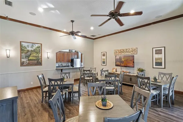 a view of a dining room with furniture a chandelier and wooden floor