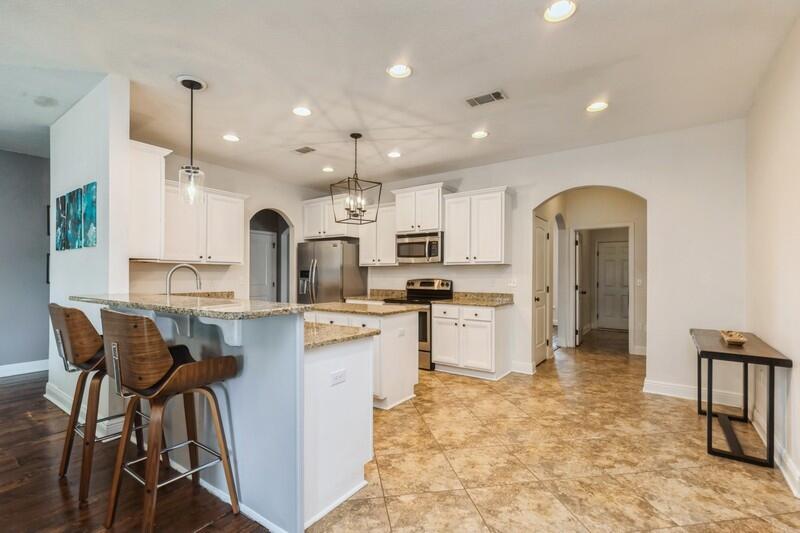 3362 Citrine Circle Crestview, FL 32539 - Photo 21 of 42 a kitchen with kitchen island granite countertop lots of white cabinets stainless steel appliances furniture and a counter top space