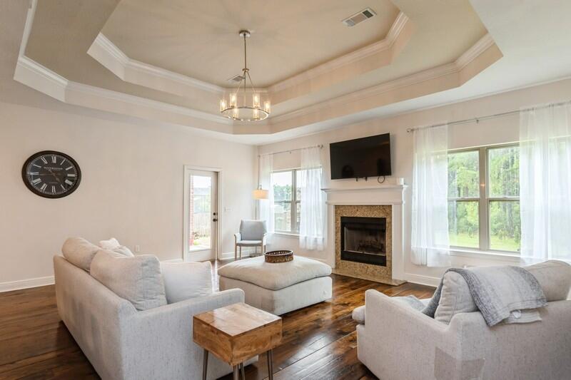 3362 Citrine Circle Crestview, FL 32539 - Photo 22 of 42 a living room with furniture a fireplace and a large window