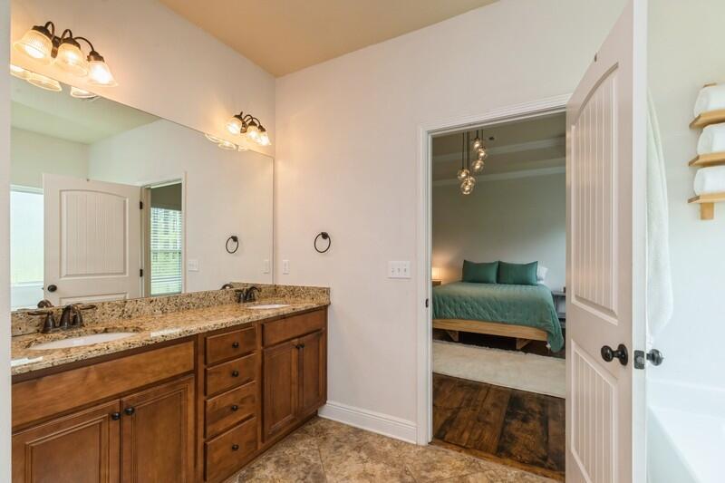 3362 Citrine Circle Crestview, FL 32539 - Photo 38 of 42 a spacious bathroom with a granite countertop sink and a mirror