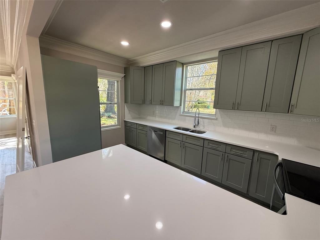 1217 Northeast 4 Street Gainesville, FL 32601 - Photo 12 of 36 a kitchen with a sink cabinets and window