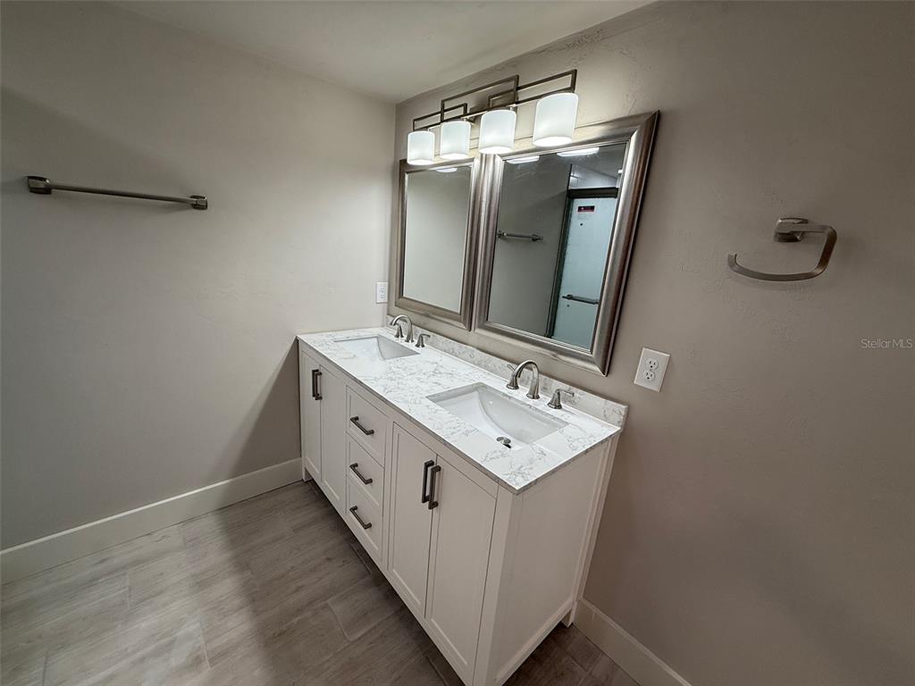 1217 Northeast 4 Street Gainesville, FL 32601 - Photo 16 of 36 a bathroom with a sink a mirror and vanity