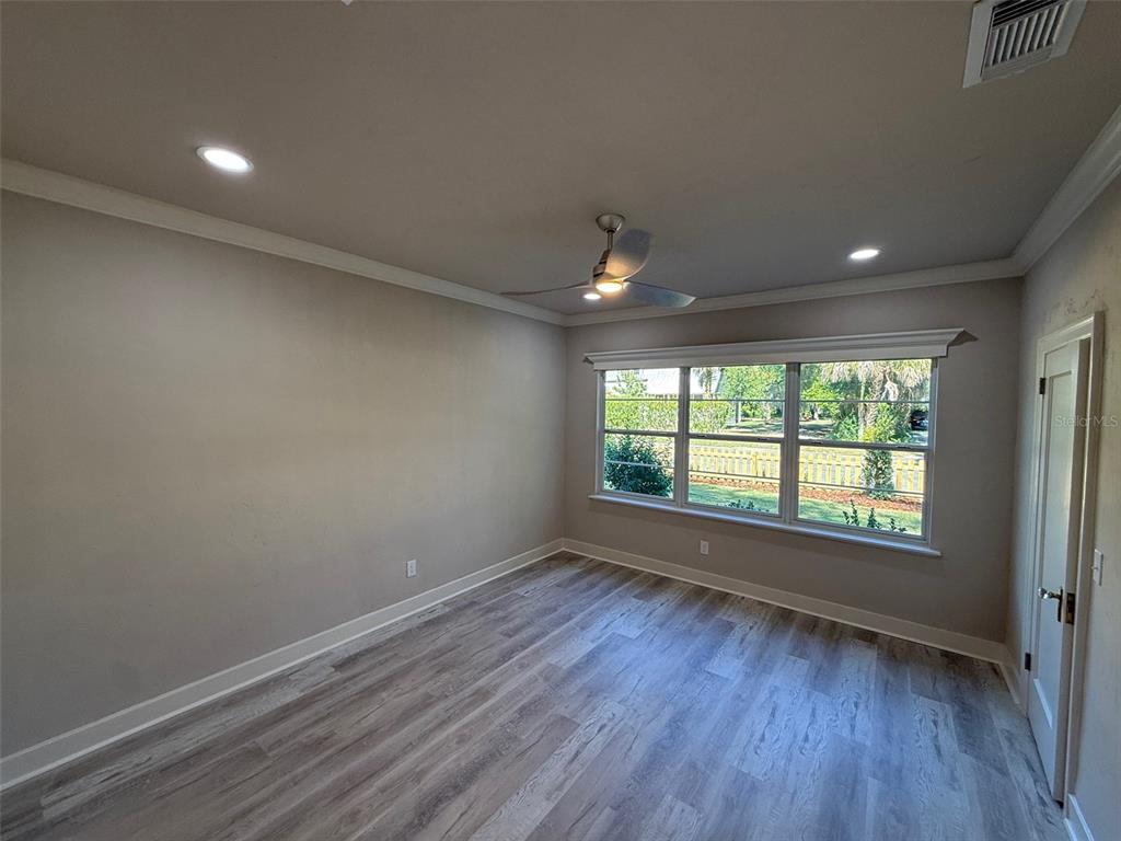 1217 Northeast 4 Street Gainesville, FL 32601 - Photo 19 of 36 wooden floor in an empty room with a window