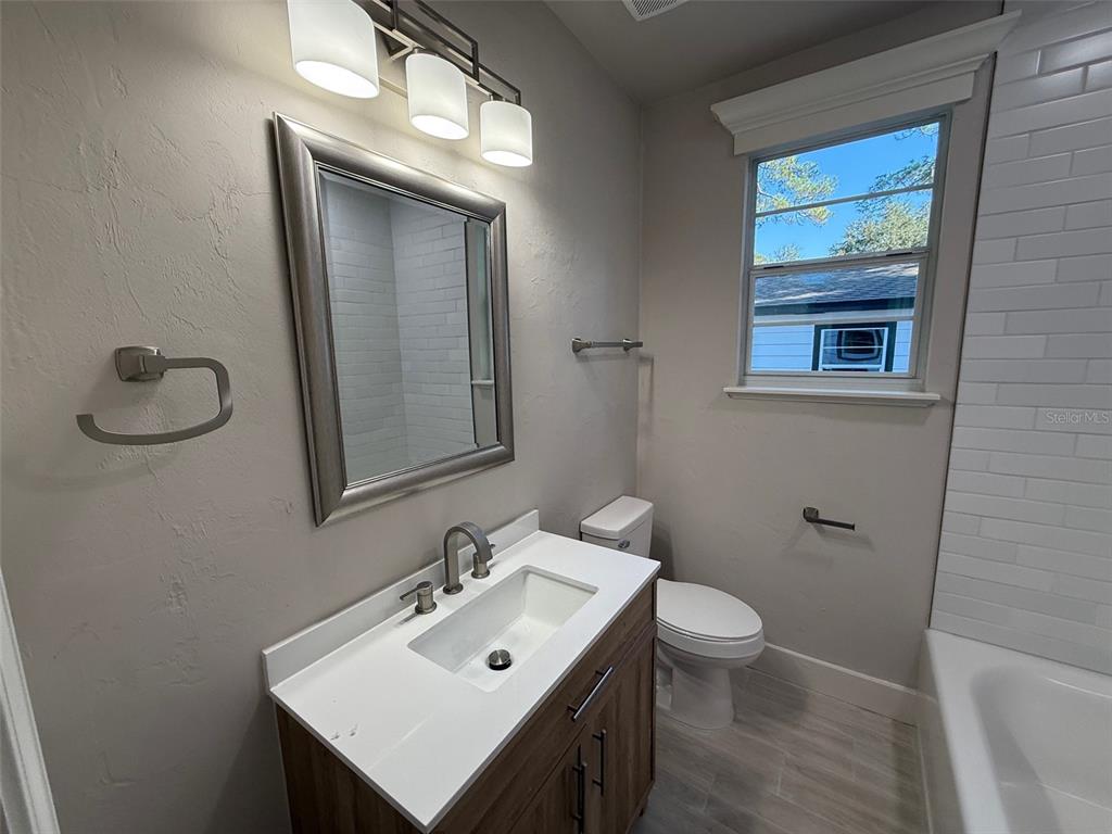 1217 Northeast 4 Street Gainesville, FL 32601 - Photo 20 of 36 a bathroom with a sink toilet and mirror