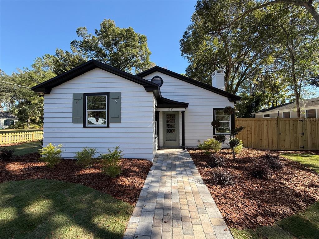 1217 Northeast 4 Street Gainesville, FL 32601 - Photo 2 of 36 a backyard of a house with table and chairs