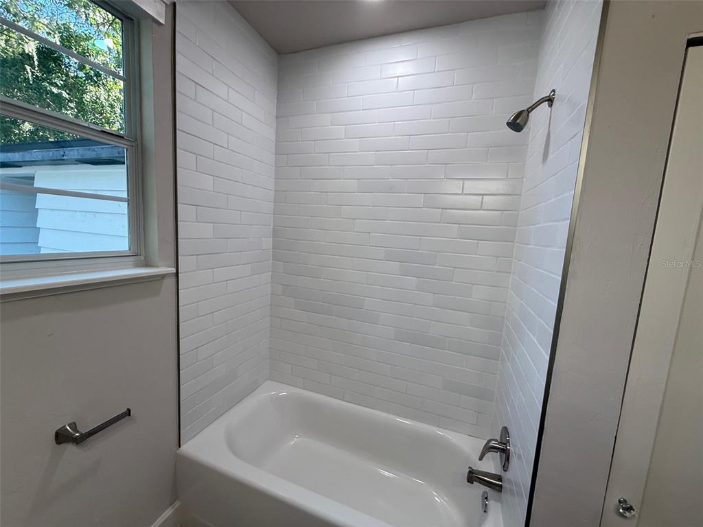 1217 Northeast 4 Street Gainesville, FL 32601 - Photo 21 of 36 a bathroom with a bathtub