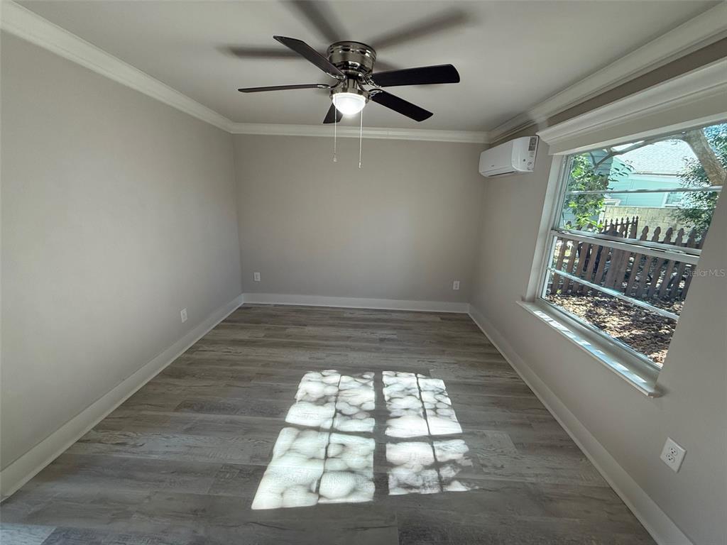 1217 Northeast 4 Street Gainesville, FL 32601 - Photo 33 of 36 en empty room with windows and ceiling fan