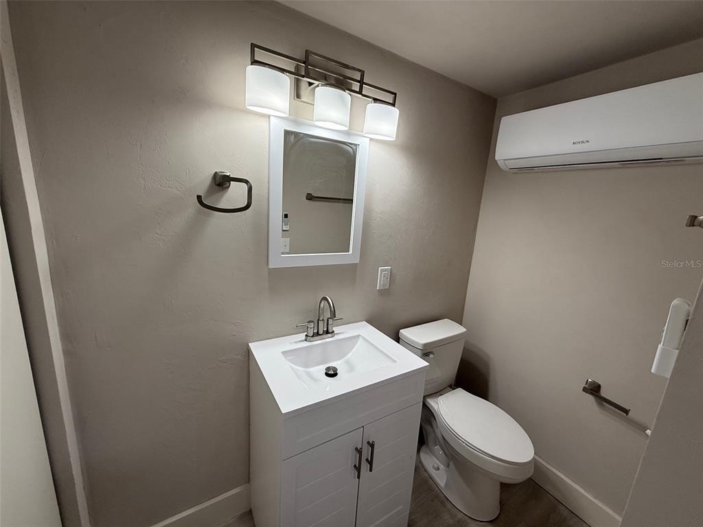 1217 Northeast 4 Street Gainesville, FL 32601 - Photo 36 of 36 a bathroom with a toilet sink and mirror