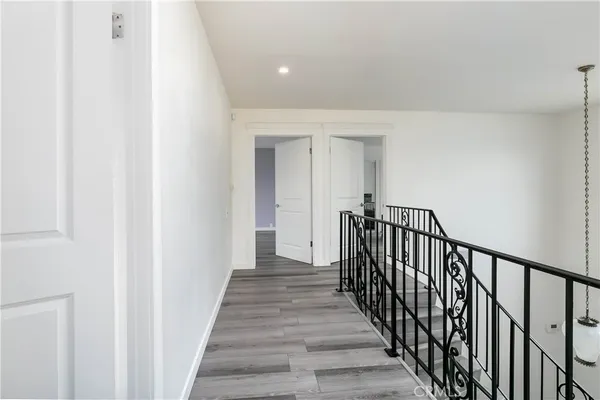 a view of a hallway with wooden floor