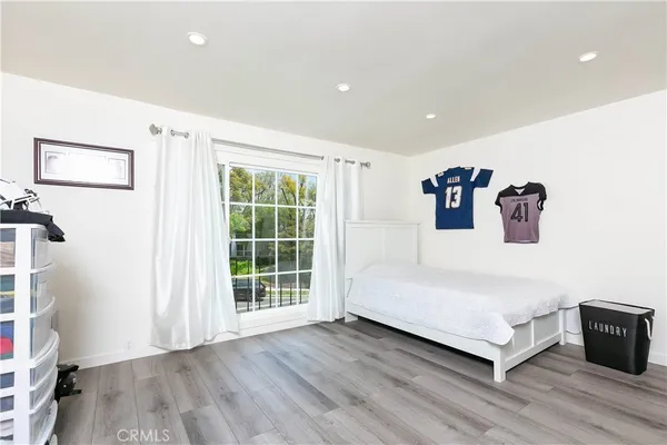 a spacious bedroom with a bed and a large window