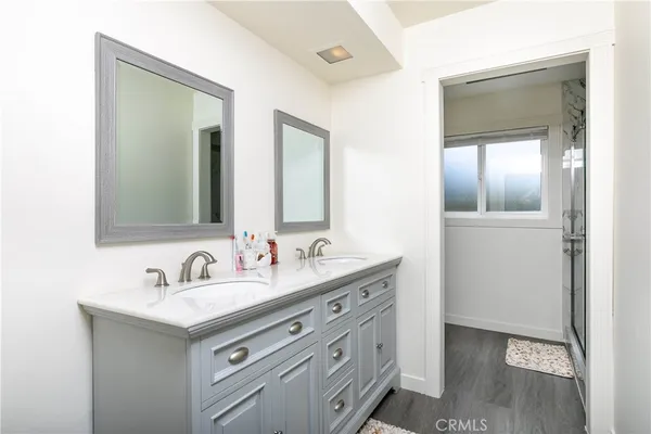 a bathroom with 2 sink and a mirror