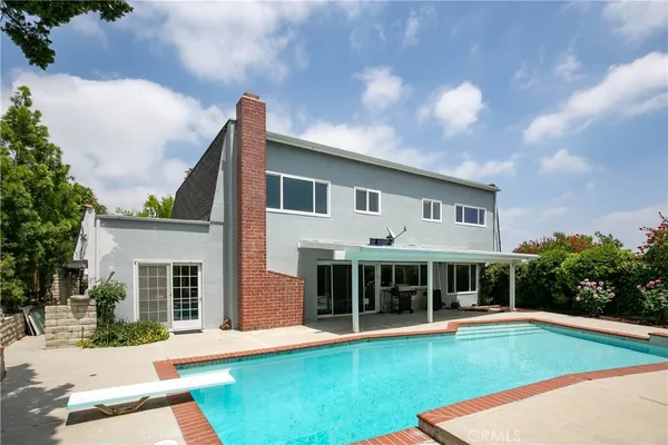 a view of a house with a yard and sitting area