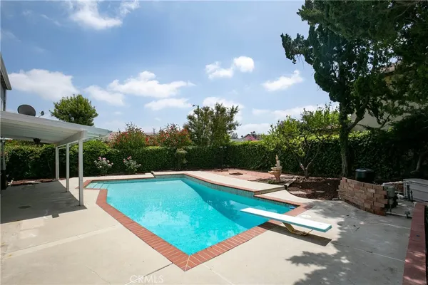 a view of swimming pool with chairs in patio