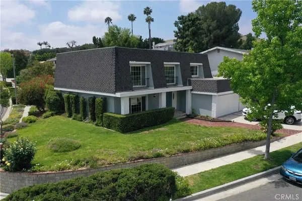 a view of house with yard and green space