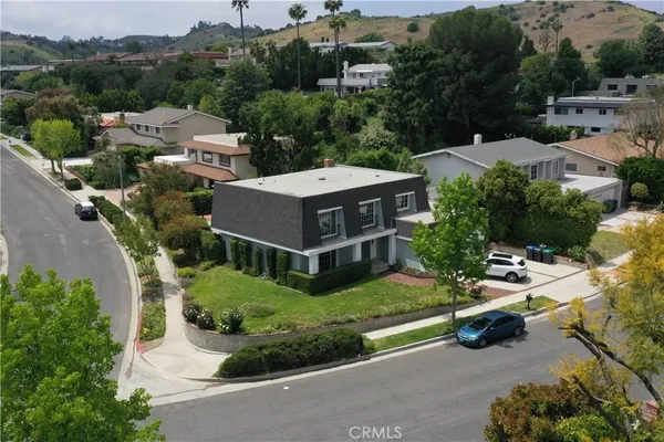 an aerial view of a house with garden space and street view