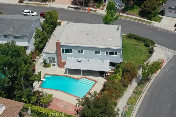 an aerial view of a house with yard swimming pool and outdoor seating
