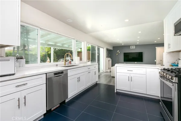 a kitchen with white cabinets and white appliances