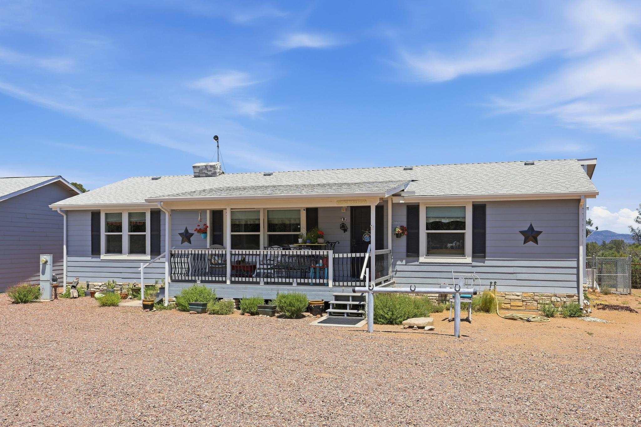 1211 Heather Circle Payson, AZ 85541 - Photo 30 of 51 a front view of a house with swimming pool and porch