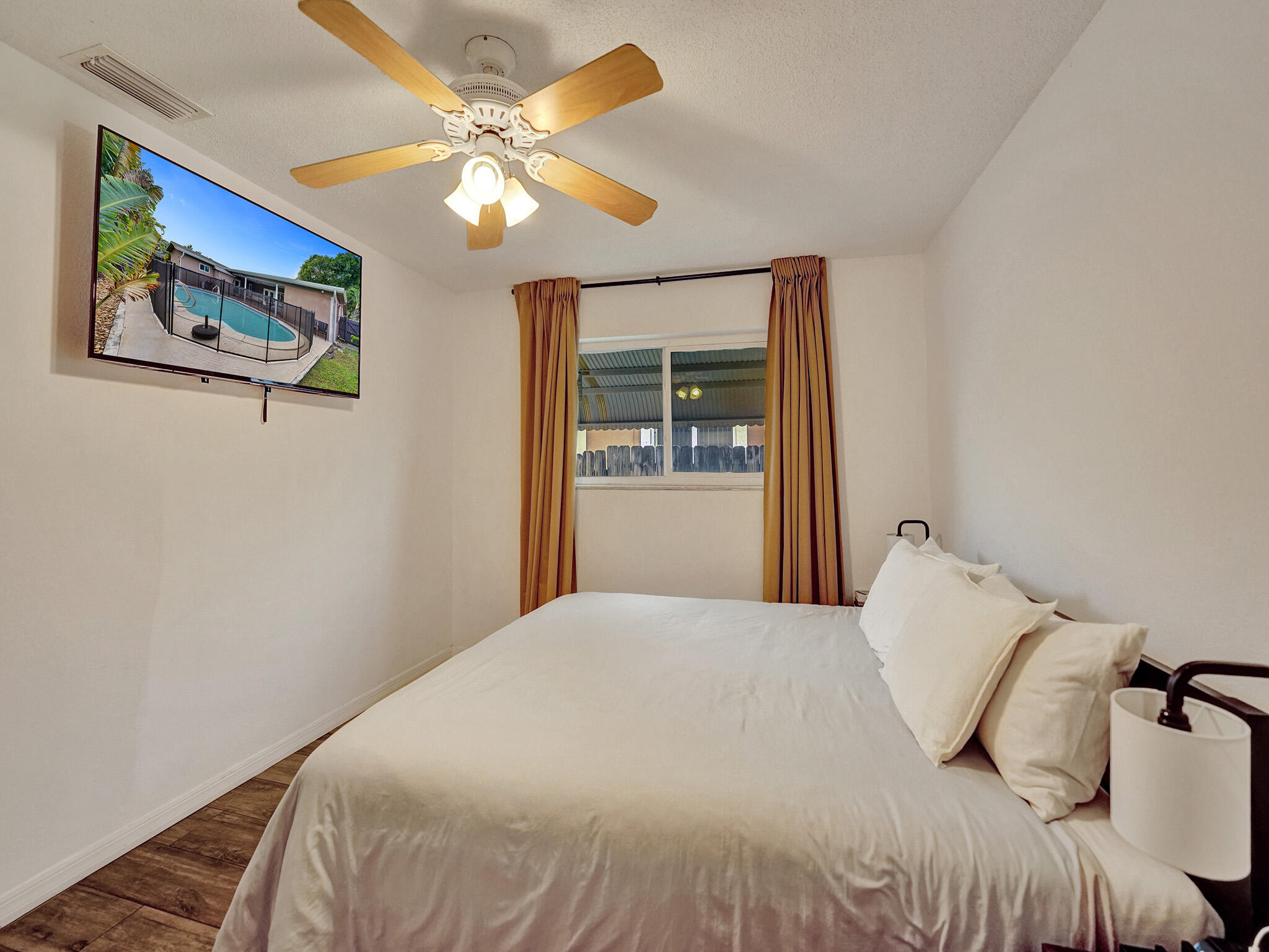 4533 Jefferson Street Hollywood, FL 33021 - Photo 14 of 29 a bedroom with a large bed and a chandelier