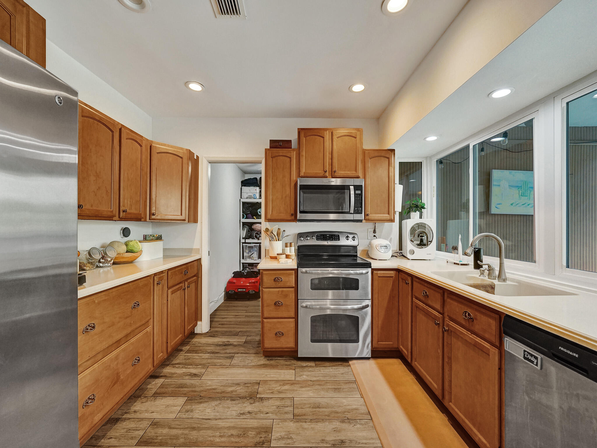 4533 Jefferson Street Hollywood, FL 33021 - Photo 16 of 29 a large kitchen with stainless steel appliances granite countertop a sink stove and refrigerator