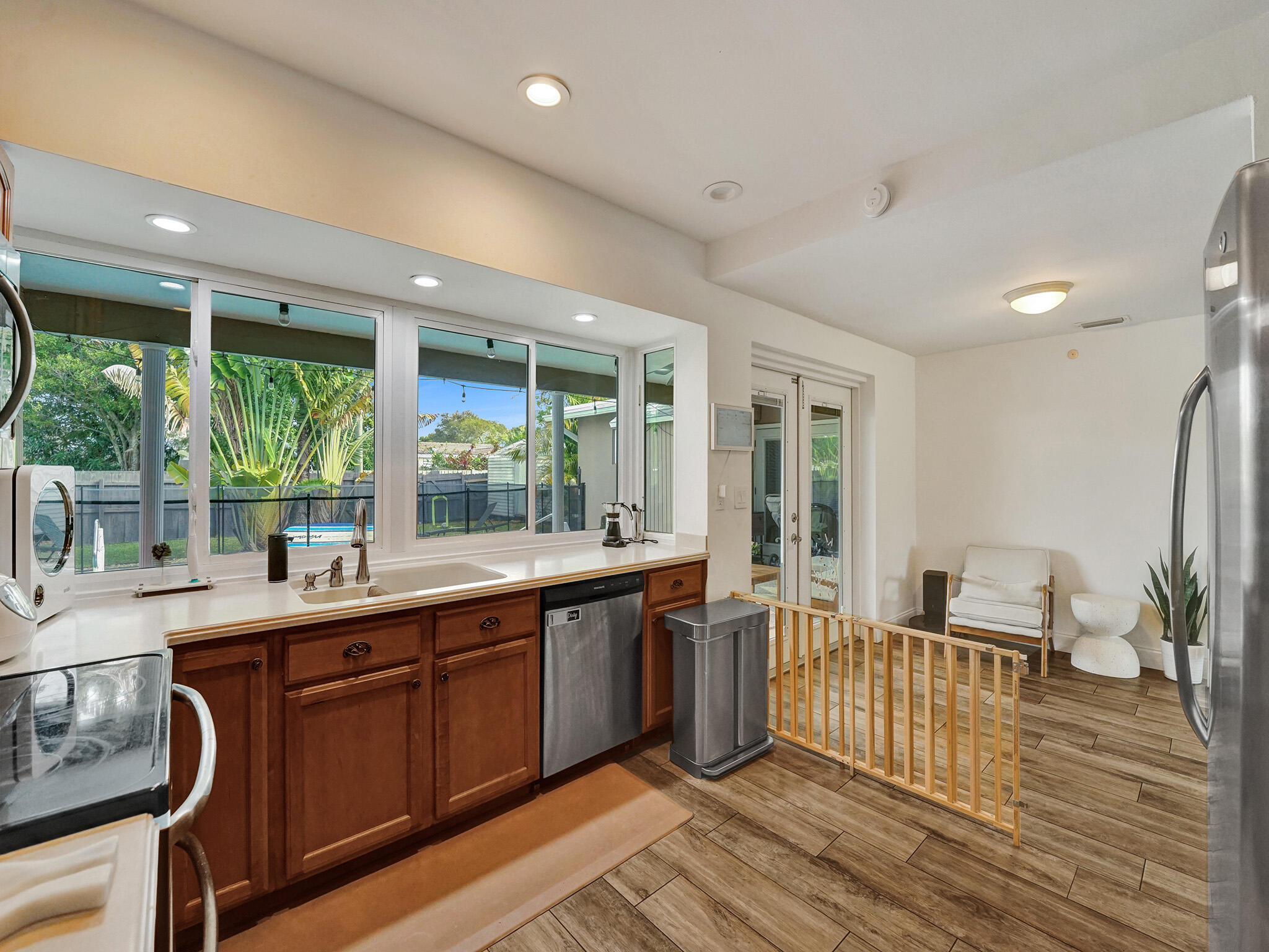 4533 Jefferson Street Hollywood, FL 33021 - Photo 18 of 29 a very nice looking kitchen with a large window wooden floor and stainless steel appliances