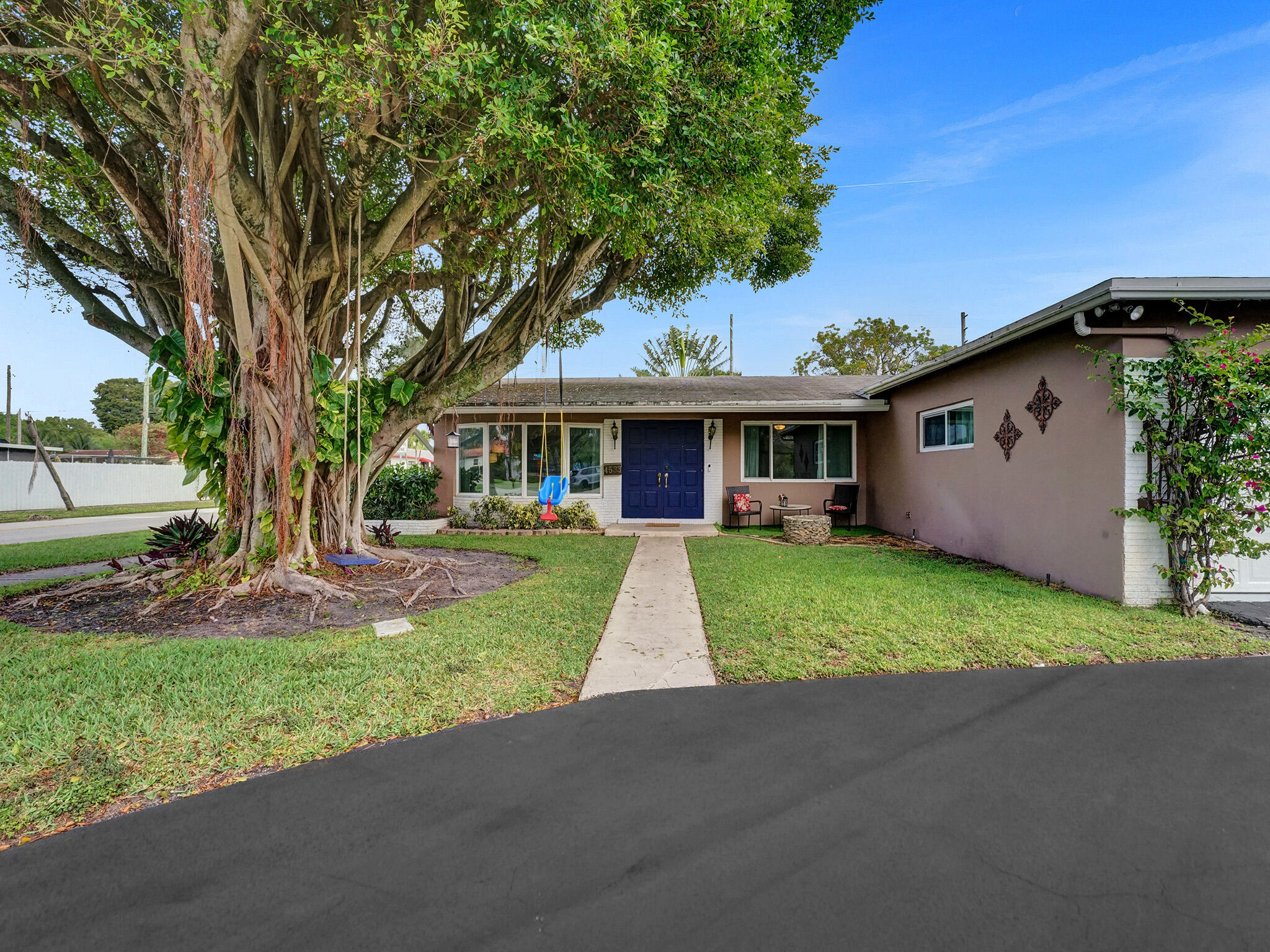 4533 Jefferson Street Hollywood, FL 33021 - Photo 2 of 29 a front view of a house with a yard