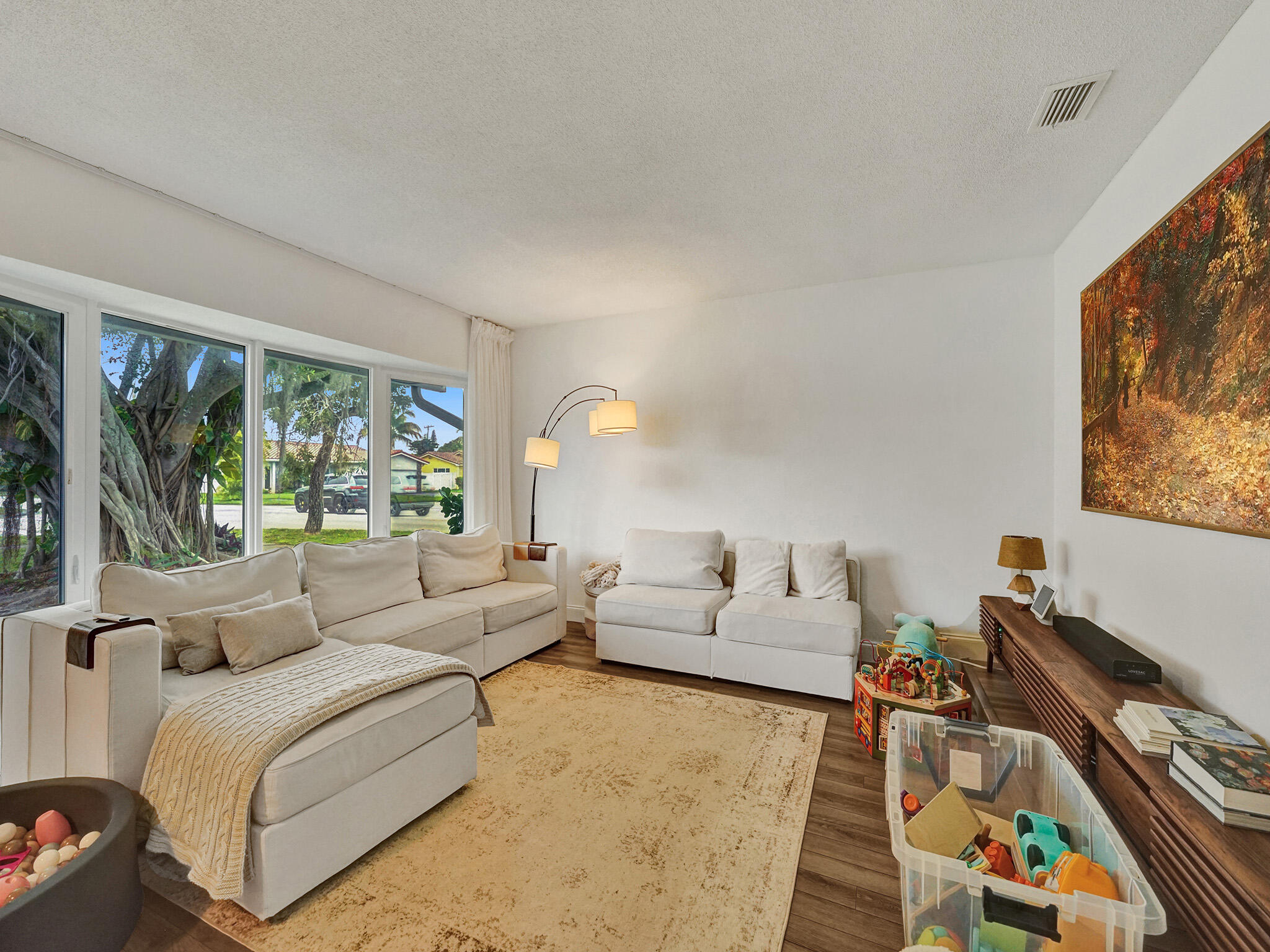 4533 Jefferson Street Hollywood, FL 33021 - Photo 4 of 29 a living room with furniture and a flat screen tv