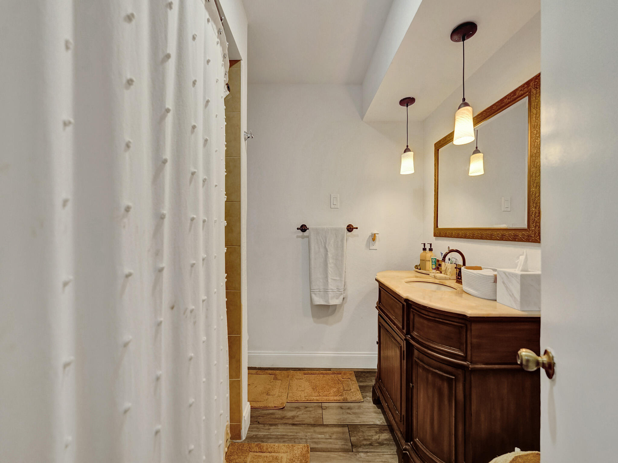 4533 Jefferson Street Hollywood, FL 33021 - Photo 9 of 29 a bathroom with a sink a mirror and shower