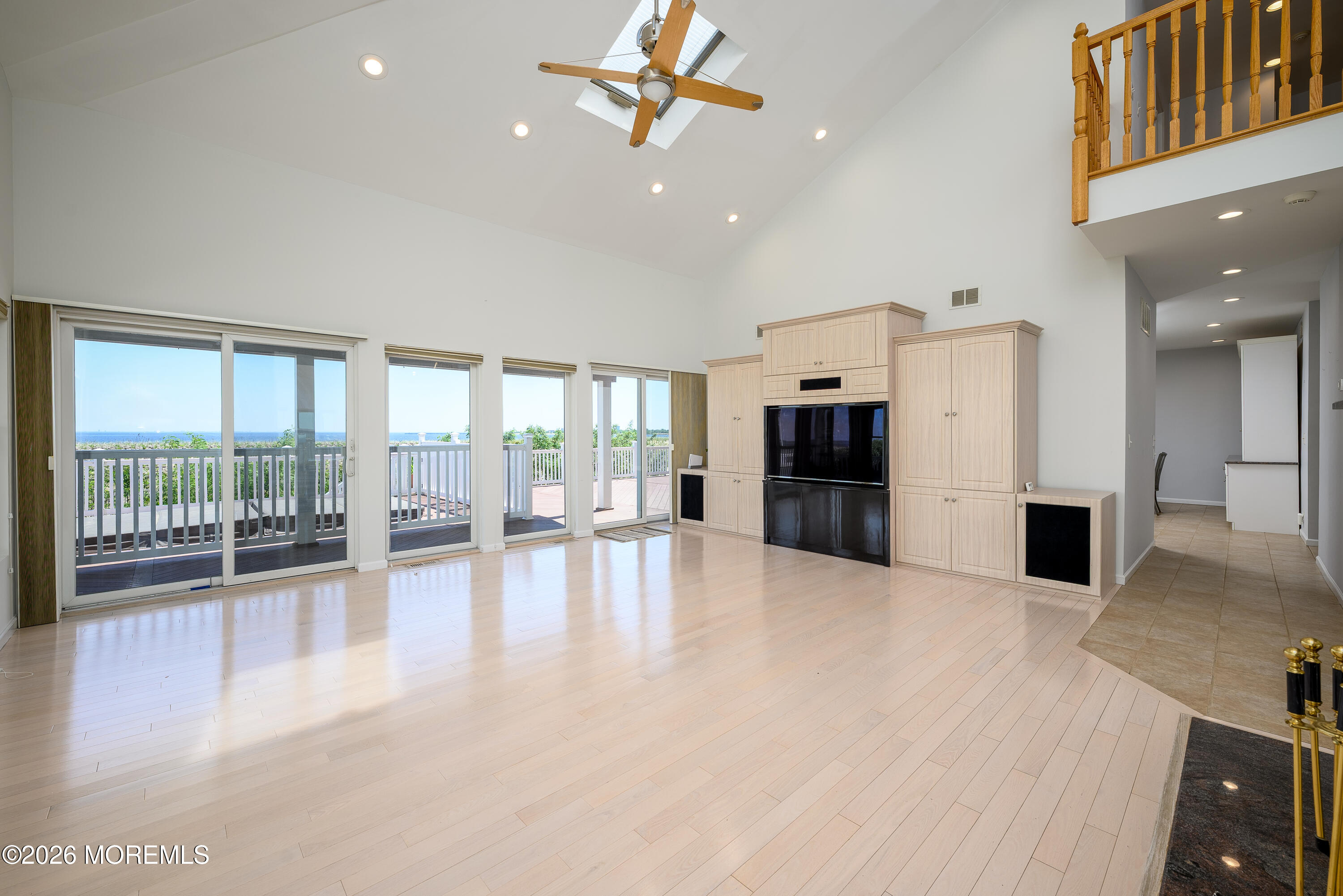 805 Front Street Union Beach, NJ 07735 - Photo 7 of 65 a view of an empty room with a fireplace and large windows