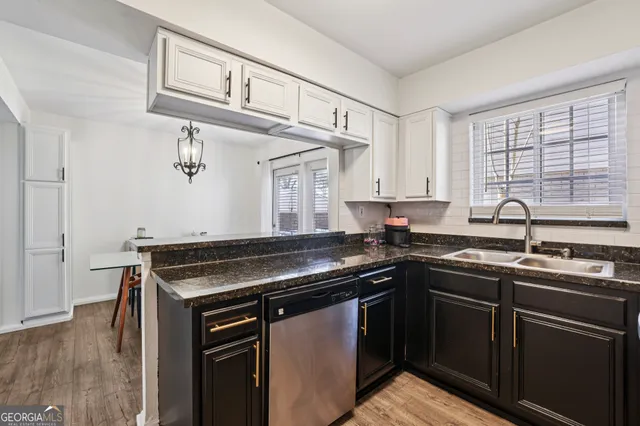 a kitchen with stainless steel appliances granite countertop a sink stove and cabinets
