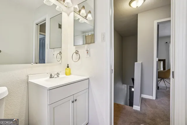 a bathroom with a sink vanity and a mirror