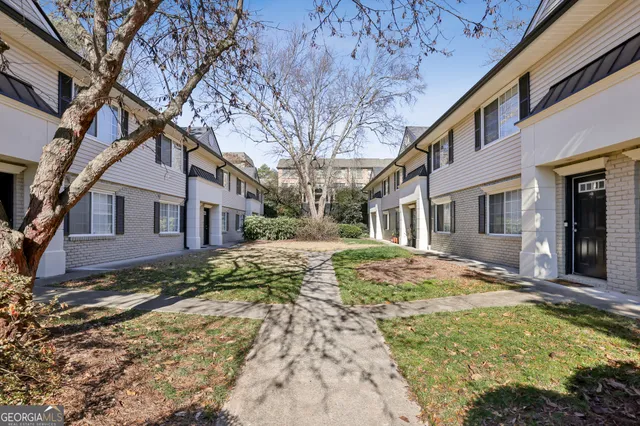a view of a yard in front of a brick house
