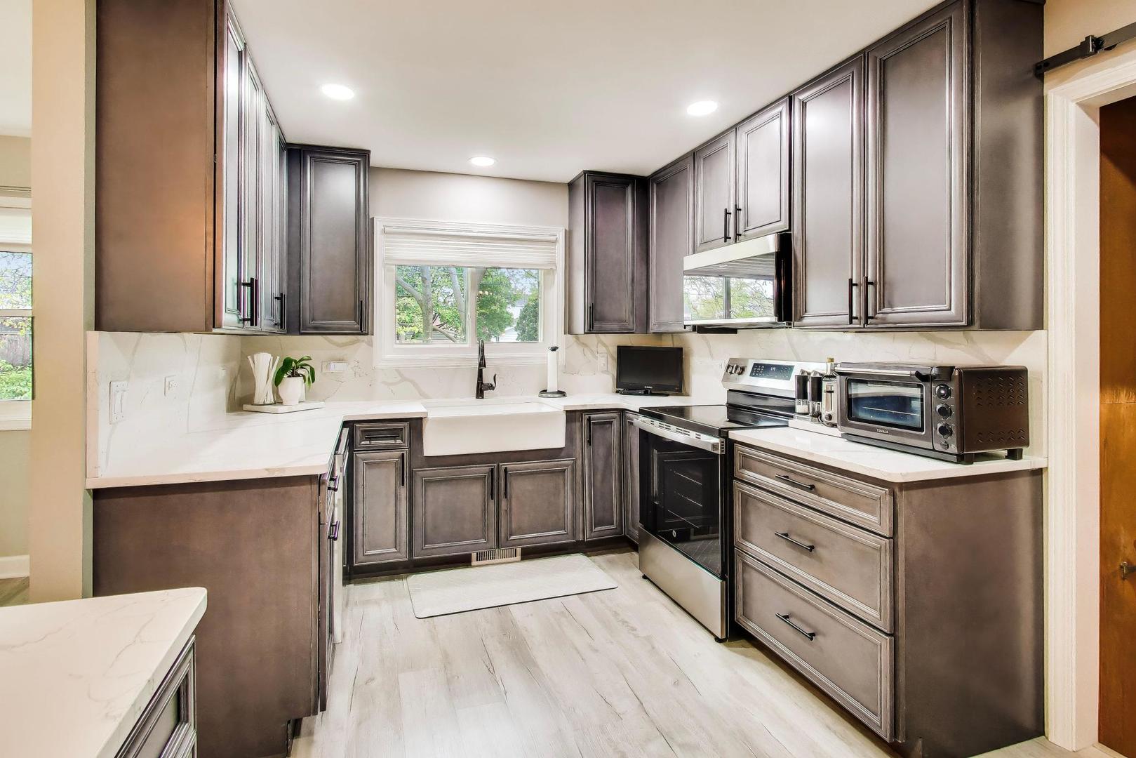 313 South Hi Lusi Avenue Mount Prospect, IL 60056 - Photo 10 of 40 a kitchen with a sink stove top oven and cabinets