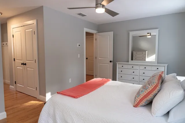 a bedroom with a bed and a mirror