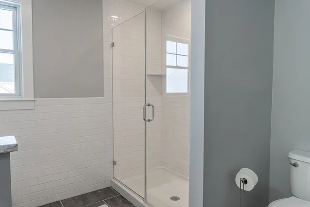 a bathroom with a shower and toilet
