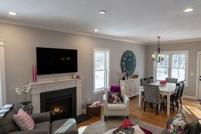 a living room with furniture fireplace and window