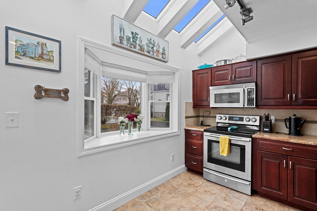2 Chase Lane, Unit 2 Lynn, MA 01902 - Photo 14 of 42 a kitchen with stainless steel appliances granite countertop a stove and a refrigerator