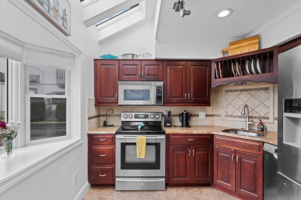 2 Chase Lane, Unit 2 Lynn, MA 01902 - Photo 15 of 42 a kitchen with stainless steel appliances granite countertop a stove and a sink