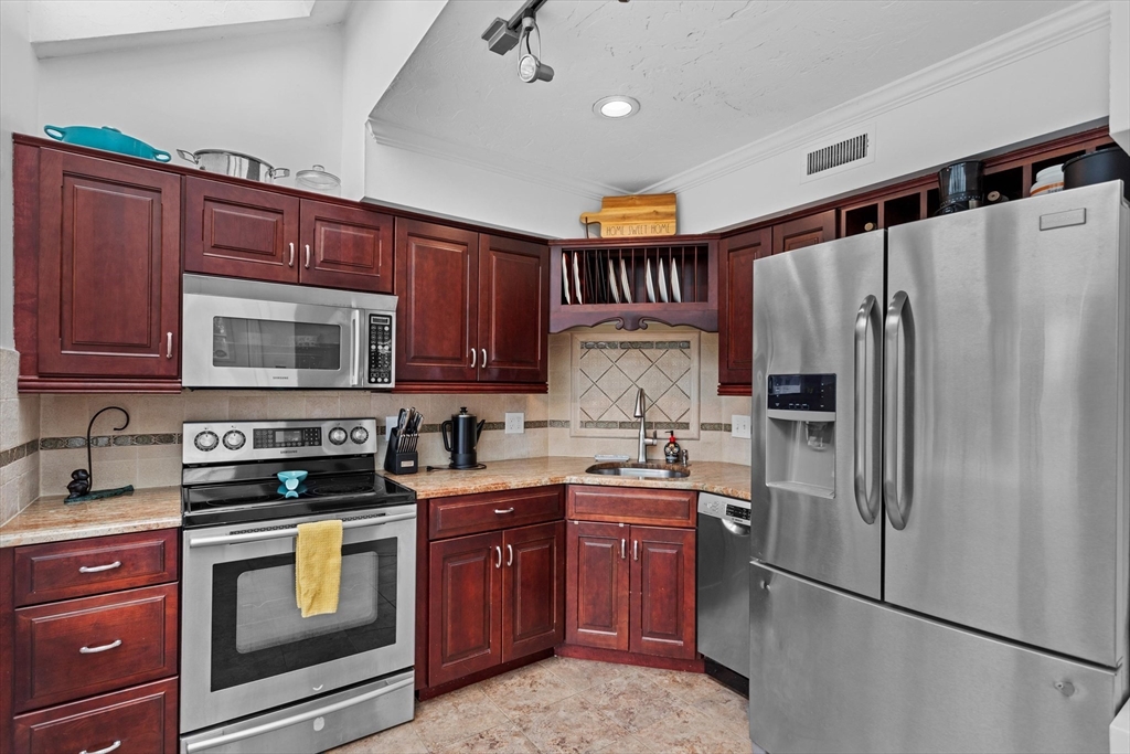 2 Chase Lane, Unit 2 Lynn, MA 01902 - Photo 16 of 42 a kitchen with stainless steel appliances granite countertop a refrigerator stove and sink