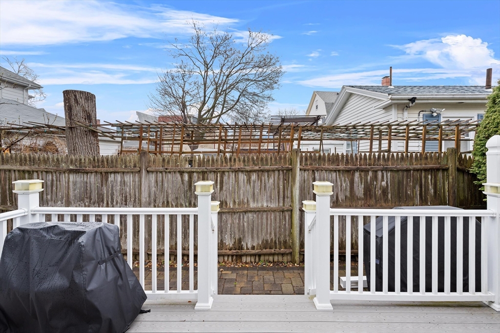 2 Chase Lane, Unit 2 Lynn, MA 01902 - Photo 23 of 42 a view of a balcony with a floor to ceiling window and wooden fence