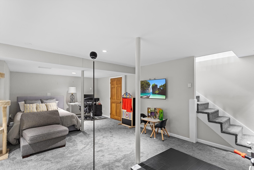 2 Chase Lane, Unit 2 Lynn, MA 01902 - Photo 33 of 42 a living room with furniture and a chandelier