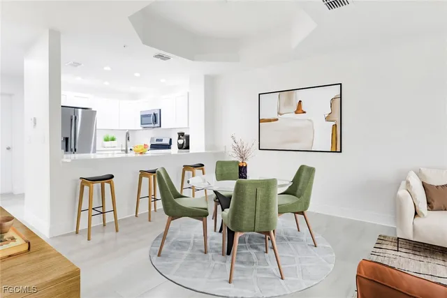 a dining room with furniture and wooden floor