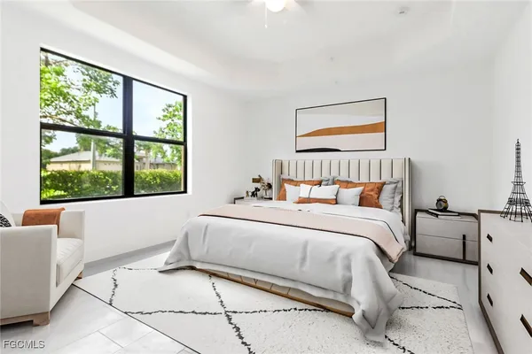 a bedroom with a bed and a large window